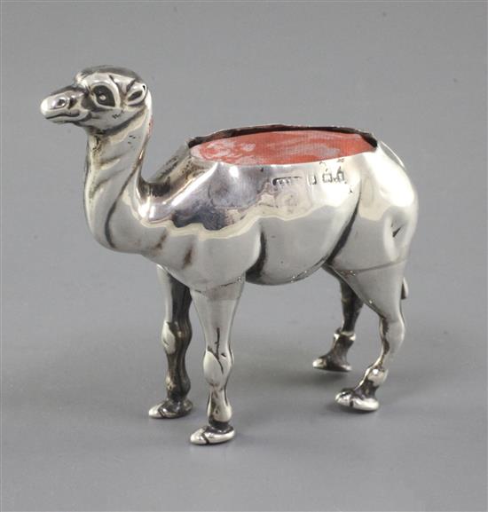An Edwardian novelty silver pin cushion modelled as a camel by Adie & Lovekin, height 2.5in.